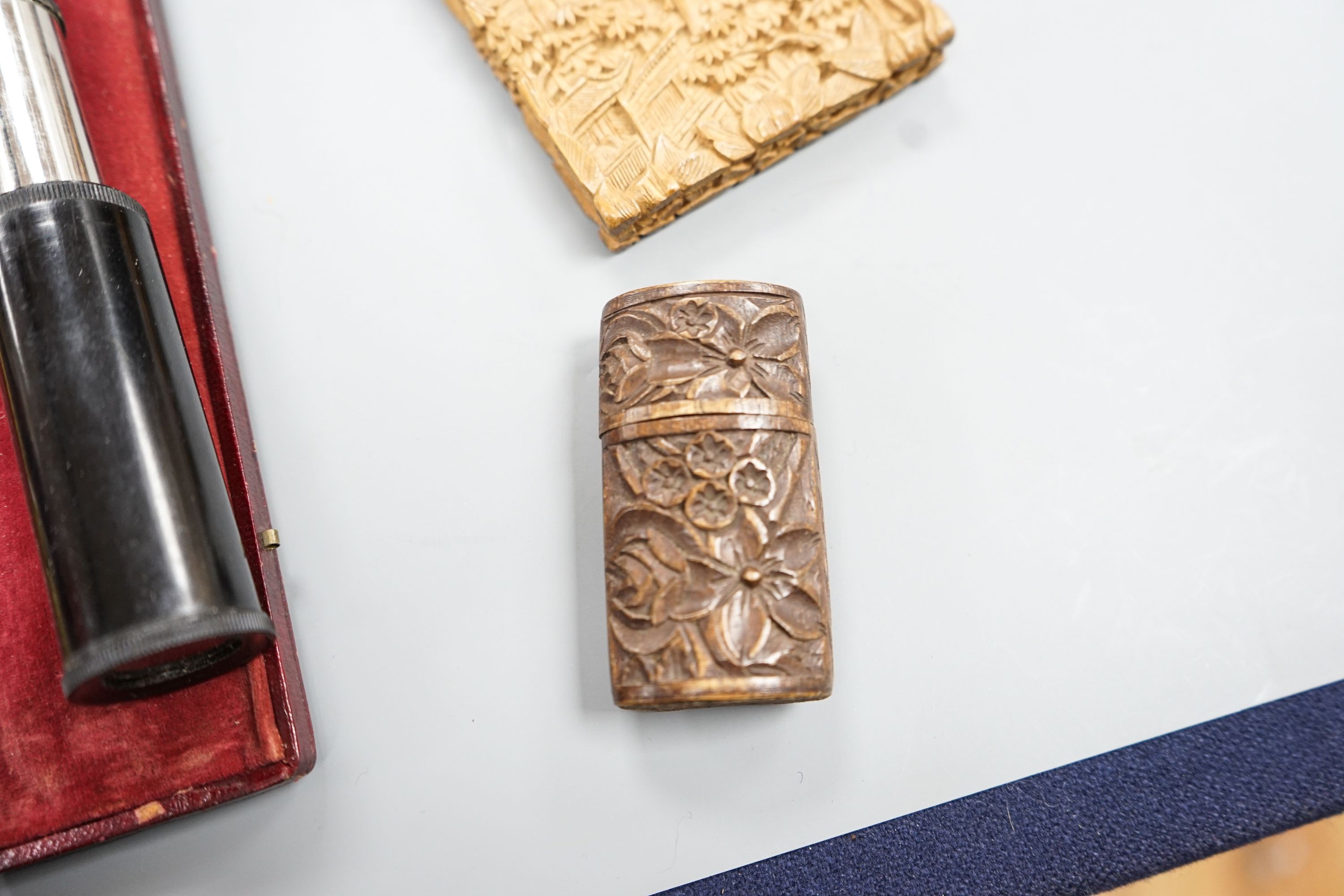 A Chinese carved sandalwood card case, a cased set of Avery gold scales, a Zonex telescope, a cased Cary prismatic instrument and a floral carved wood box.